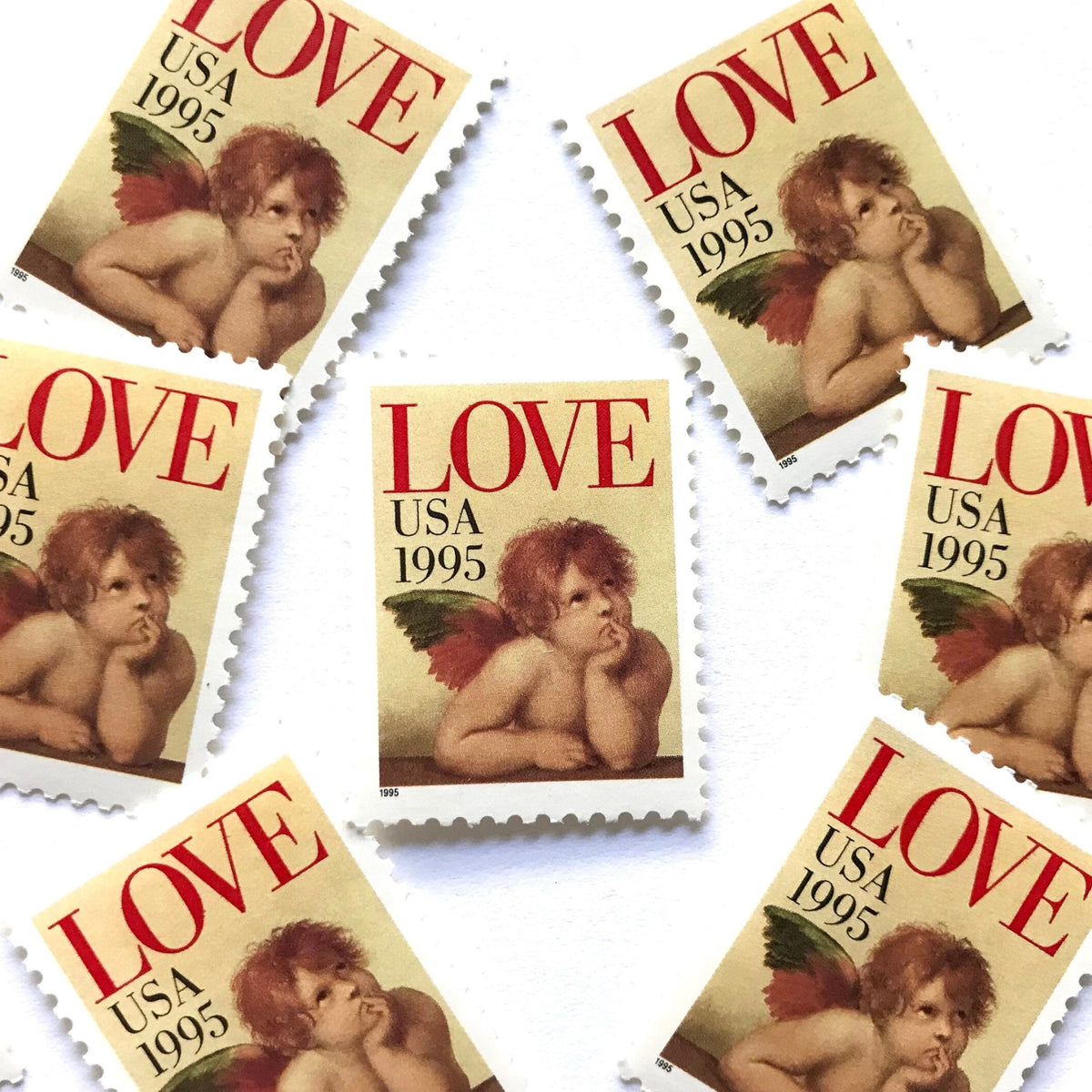 Cherub postage stamps from 1995 featuring Raphael’s contemplative cherub from the Sistine Madonna on vintage unused 32-cent USPS postage, Scott 2959.