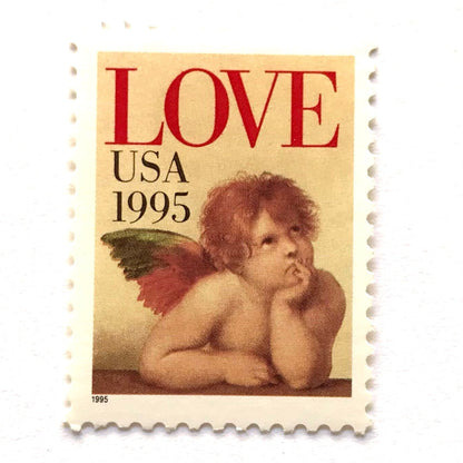Cherub postage stamps from 1995 featuring Raphael’s contemplative cherub from the Sistine Madonna on vintage unused 32-cent USPS postage, Scott 2959.