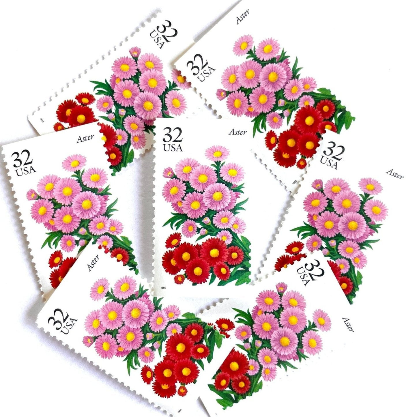 Image of 1995 Garden Flowers series “The Fall Garden: Aster” unused 32-cent vintage USPS mail stamps. Scott #2993. Stamp Themes: Flowers, Floral, Botanical, Fragrant, Gardening, Fall, Autumn, Nature. Pink, Red, Green, Multicolored gummed postage stamp. Perfect postage stamp to use for save the date announcements, wedding invitation postage, bridal shower invitations, birth announcements, thank you cards, valentine’s day, and snail mail.