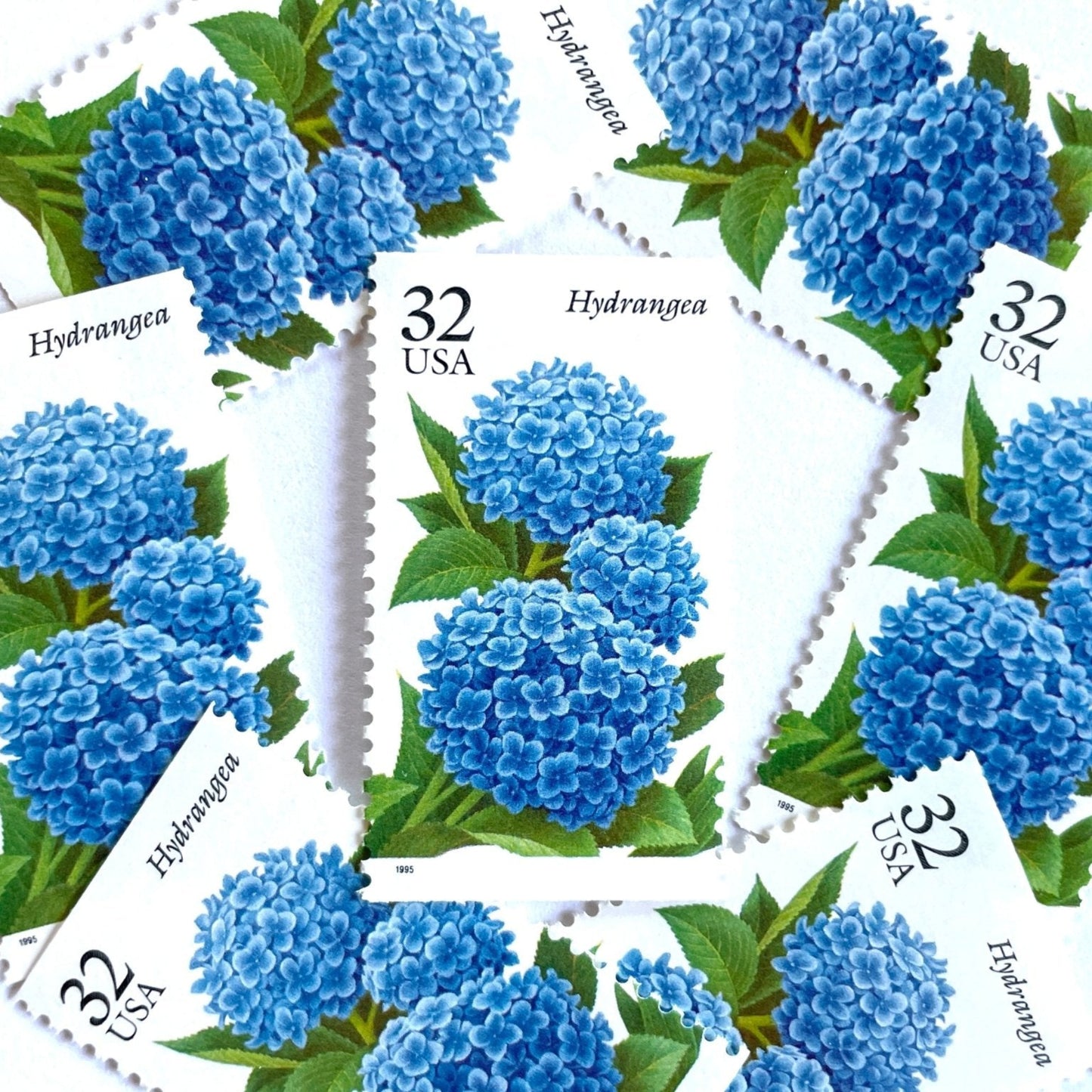 Image of 1995 The Seasonal Garden Series Fall Garden Flowers “Hydrangea” 32-cent vintage unused USPS mail stamps. Scott #2996. Stamp Themes: Flower, Floral, Botanical, Gardening, Nature, Seasons, Fall, Fall Garden Flowers. Blue, Light Blue, Green, Multicolored postage stamp. Perfect vintage postage stamp to use for save the date announcements, wedding invitation postage, shower invitations, thank you cards, and snail mail.