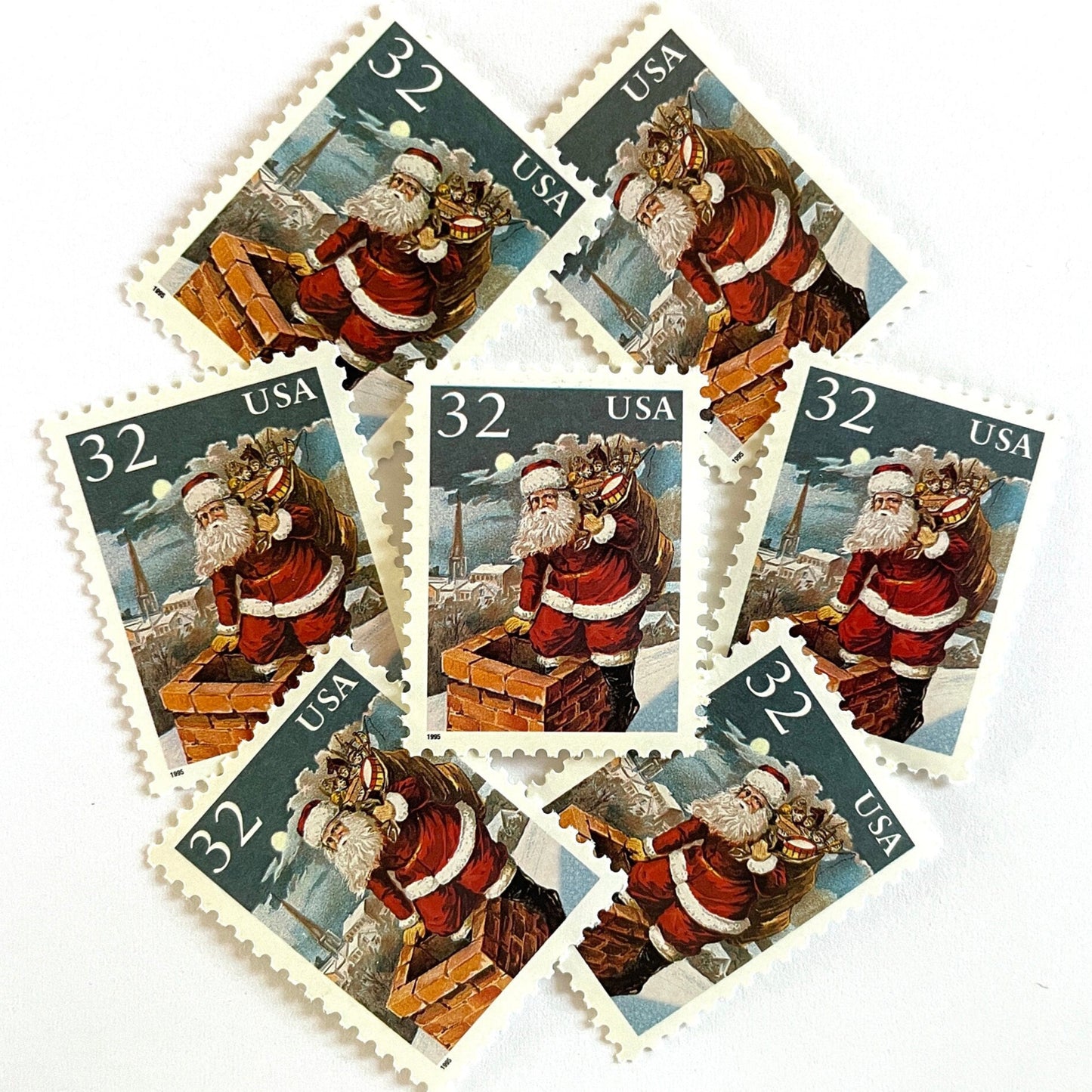Image of 32-cent Contemporary Christmas 1995 Santa and Children “Santa & Chimney” USPS postage stamps featuring Santa Claus on a rooftop entering a chimney, dressed in his traditional red suit with white trim and a fur-lined hat, depicted with a long white beard and a sack full of toys slung over his shoulder. Scott #3004. Stamp themes: Christmas, holidays, winter, Santa Claus, toys, gifts, winter wedding, winter save-the-date. Red and blue postage stamp.