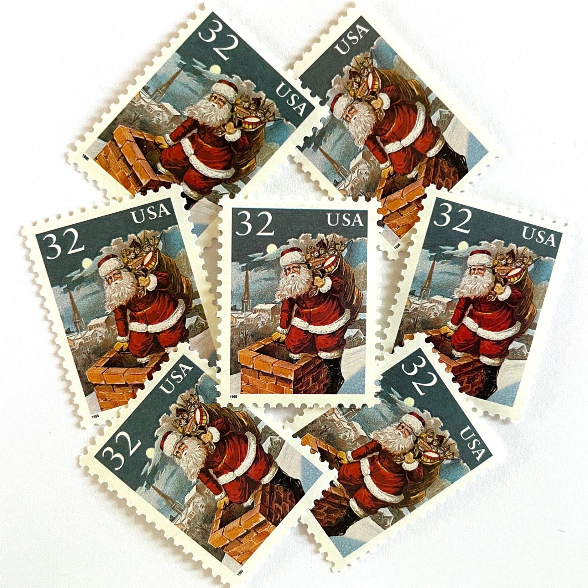 Image of 32-cent Contemporary Christmas 1995 Santa and Children “Santa & Chimney” USPS postage stamps featuring Santa Claus on a rooftop entering a chimney, dressed in his traditional red suit with white trim and a fur-lined hat, depicted with a long white beard and a sack full of toys slung over his shoulder. Scott #3004. Stamp themes: Christmas, holidays, winter, Santa Claus, toys, gifts, winter wedding, winter save-the-date. Red and blue postage stamp.