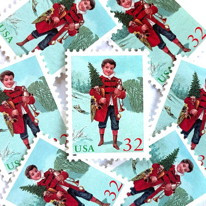 Image of 32-cent Contemporary Christmas 1995 Santa and Children “Child with Tree” USPS postage stamp featuring a boy in a red coat with dark buttons and blue trousers, wearing a ruffled white collar, stands facing forward, holding a small Christmas tree in his left arm and a toy trumpet in his right hand. Scott #3006. Stamp themes: Christmas, holidays, winter, toys, gifts, winter wedding, winter save-the-date. Green and red postage stamp.