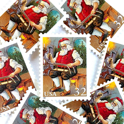 Image of 32-cent Contemporary Christmas 1995 Santa and Children “Santa Building a Sled” USPS postage stamps featuring a classic illustration of Santa Claus at work in his workshop, depicted sitting on a wooden bench, wearing his traditional red suit and hat, with a long white beard and spectacles, building a toy sled. Scott #3007. Stamp themes: Christmas, holidays, winter, toys, gifts, winter wedding, winter save-the-date. Red postage stamp.