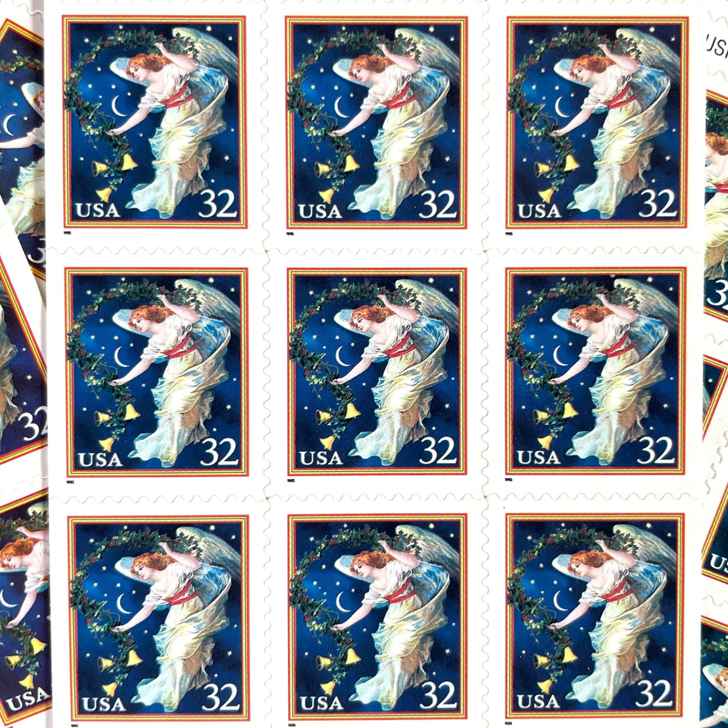 Image of 1995 Christmas “Midnight Angel” 32-cent stamps. Scott #3012. Stamp Themes: Christmas, Holidays, Angel, Celestial, Heavens, Bells, Night Sky, Victorian Christmas. Blue postage stamp.