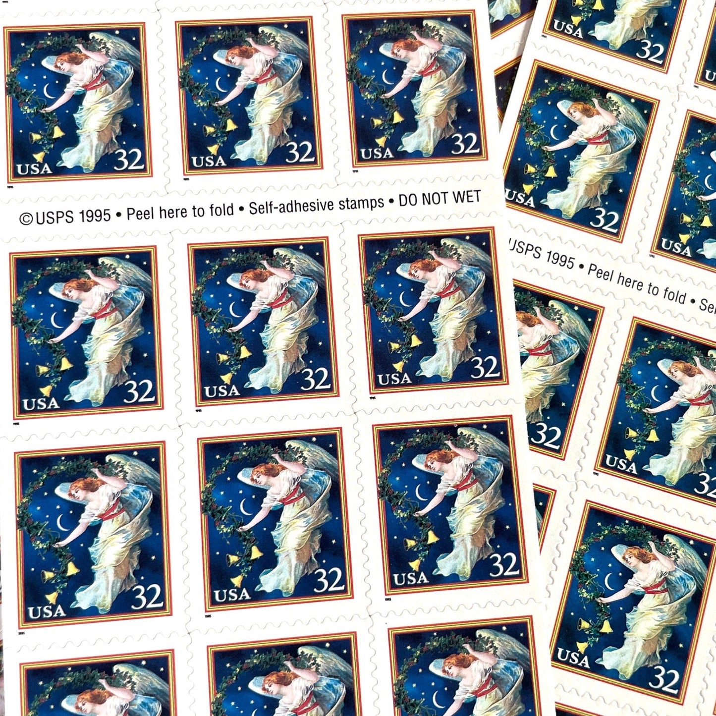 Image of 1995 Christmas “Midnight Angel” 32-cent stamps. Scott #3012. Stamp Themes: Christmas, Holidays, Angel, Celestial, Heavens, Bells, Night Sky, Victorian Christmas. Blue postage stamp.