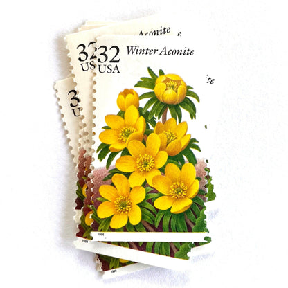 Image of vintage 1996 USPS Winter Aconite postage stamps from the Winter Garden Flowers series, featuring yellow flowers with green foliage and brown garden soil, 32-cent face value, Scott Number 3026.