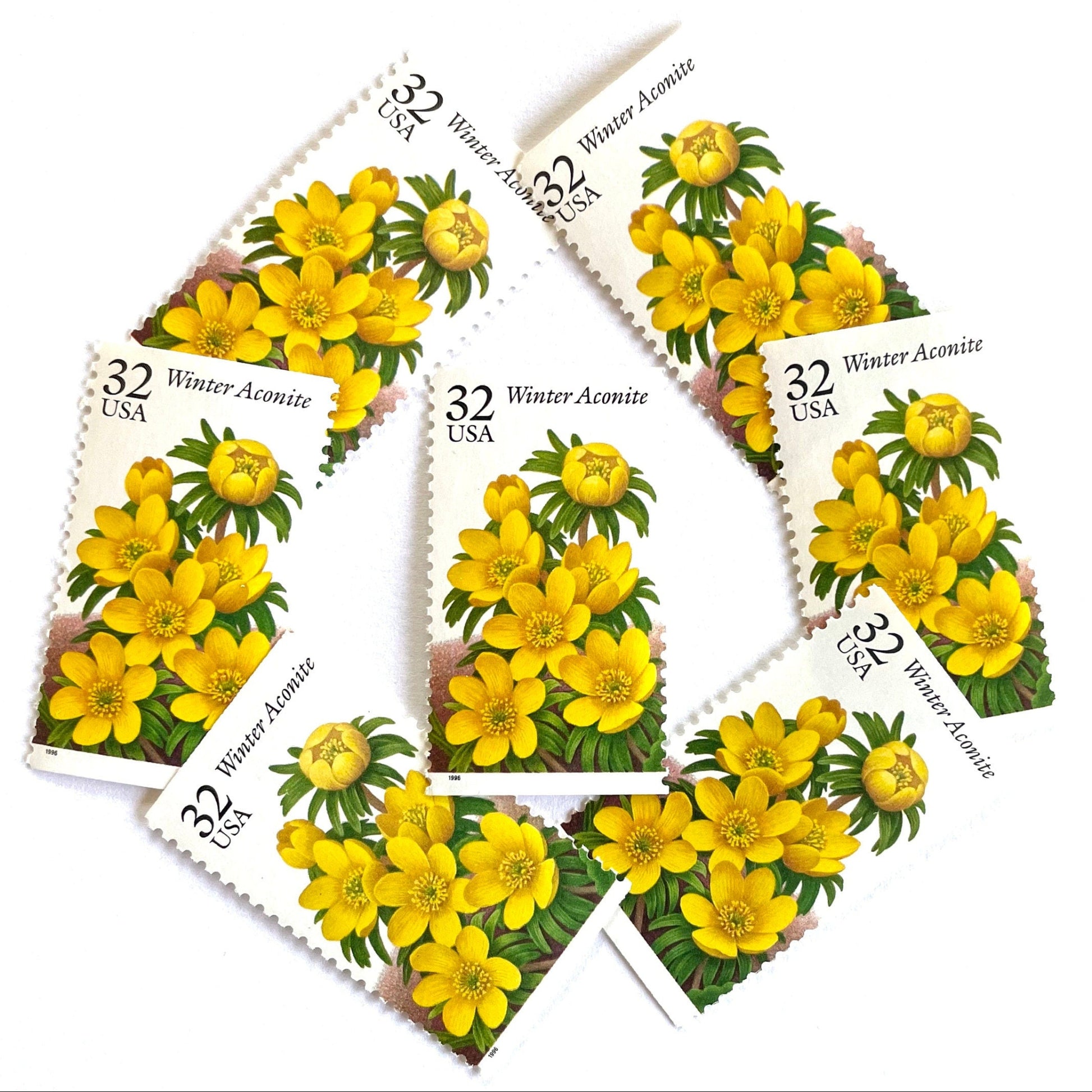 Image of vintage 1996 USPS Winter Aconite postage stamps from the Winter Garden Flowers series, featuring yellow flowers with green foliage and brown garden soil, 32-cent face value, Scott Number 3026.