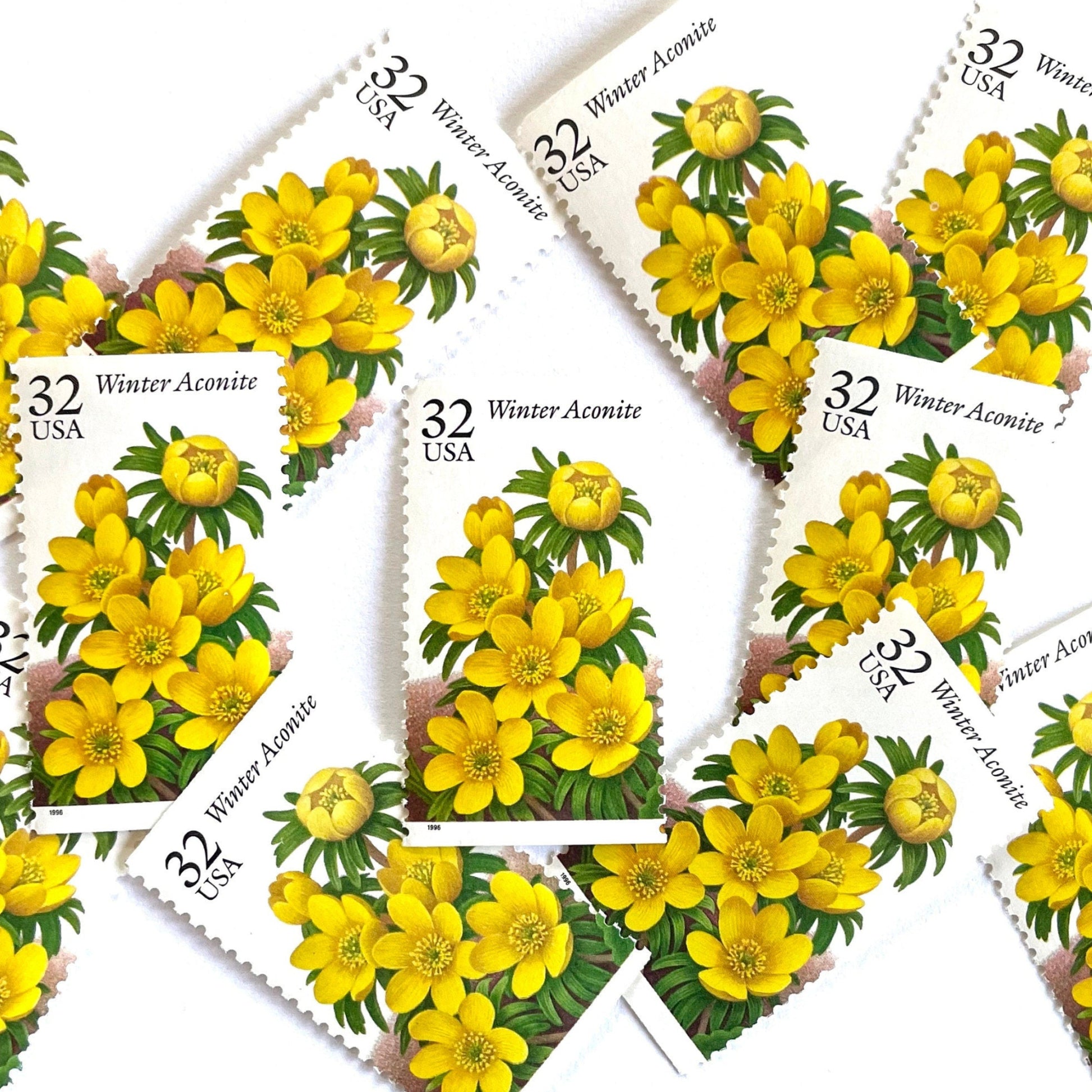 Image of vintage 1996 USPS Winter Aconite postage stamps from the Winter Garden Flowers series, featuring yellow flowers with green foliage and brown garden soil, 32-cent face value, Scott Number 3026.