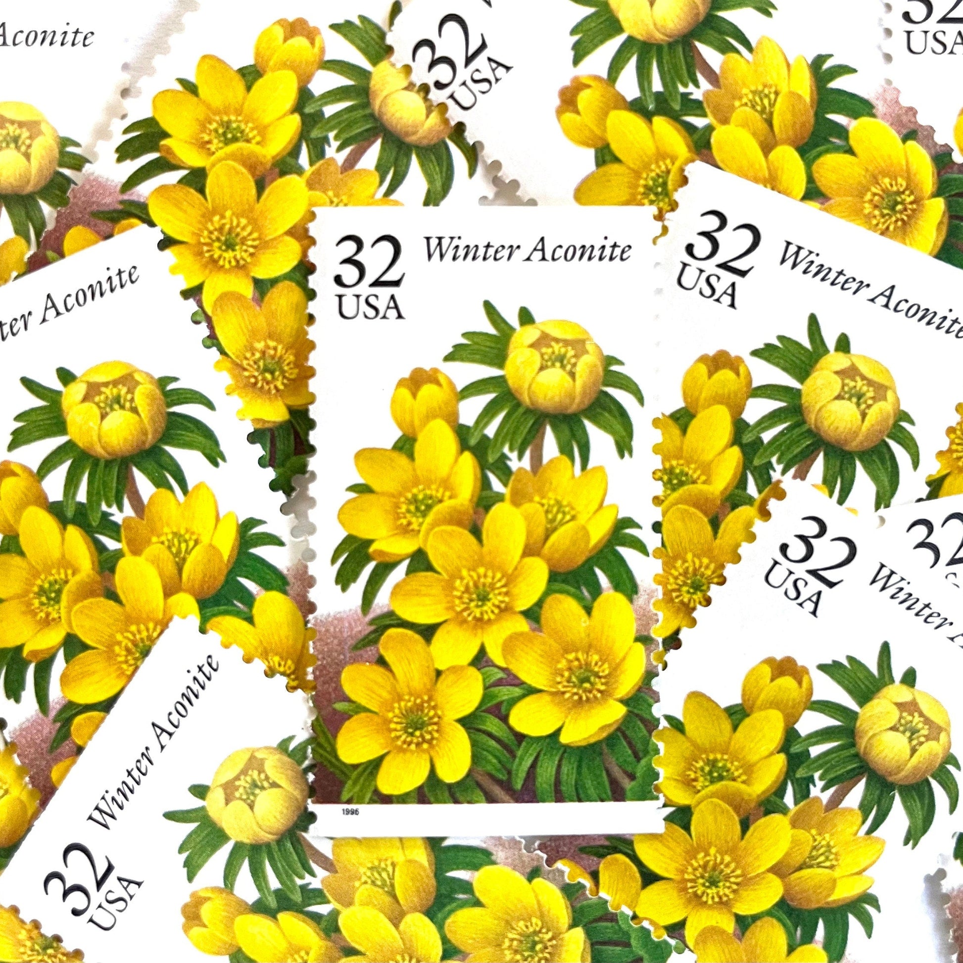 Image of vintage 1996 USPS Winter Aconite postage stamps from the Winter Garden Flowers series, featuring yellow flowers with green foliage and brown garden soil, 32-cent face value, Scott Number 3026.