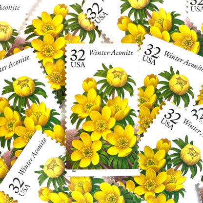 Image of vintage 1996 USPS Winter Aconite postage stamps from the Winter Garden Flowers series, featuring yellow flowers with green foliage and brown garden soil, 32-cent face value, Scott Number 3026.