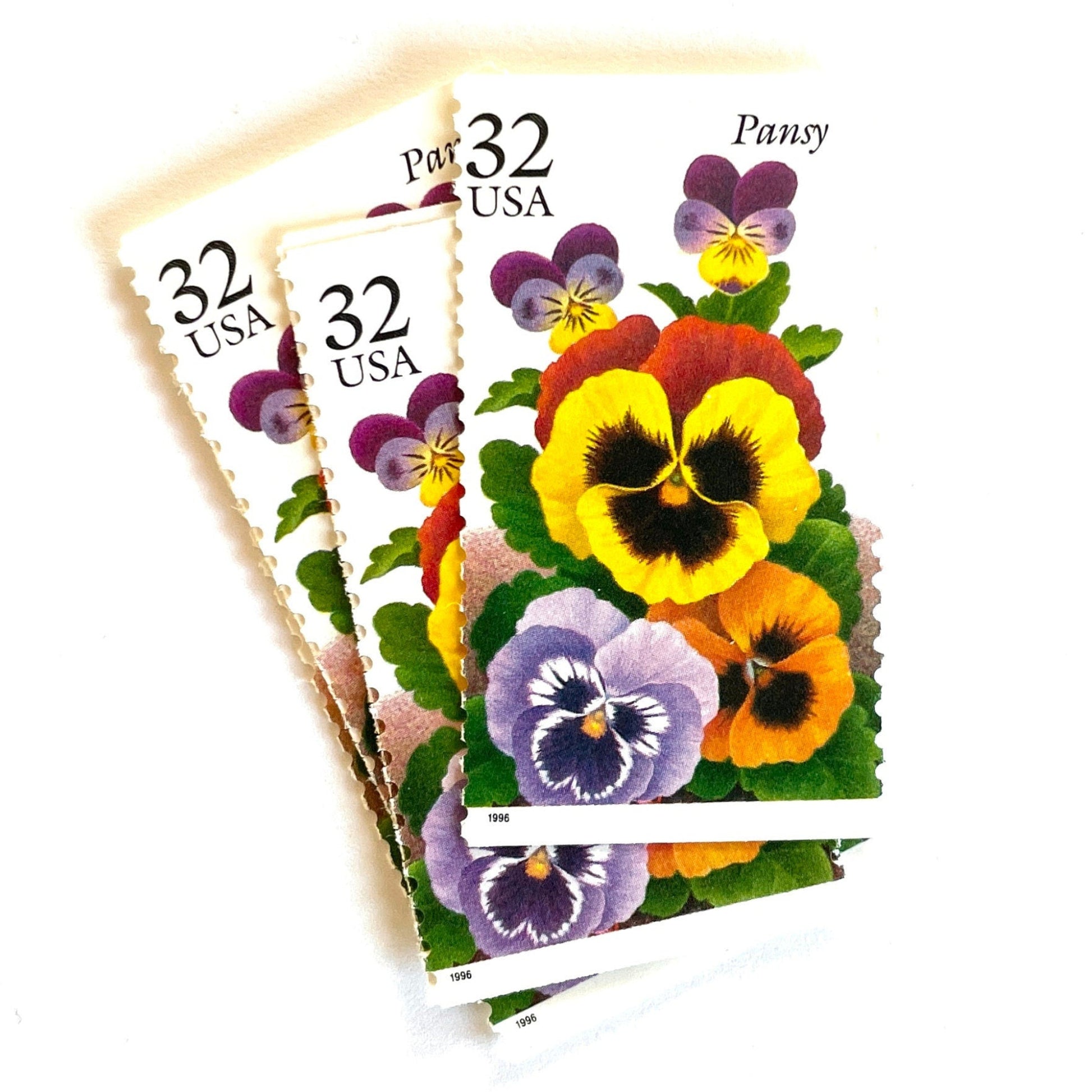 1996 32c Winter Garden Flowers Pansy USPS postage stamp, Scott 3027, featuring a purple and yellow pansy with green leaves from the Garden Flowers series.