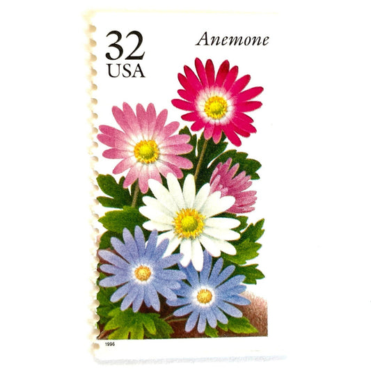 Image of Anemone postage stamps from the Winter Garden Flowers series, featuring a prink, purple, and white flowers with green foliage and garden soil on vintage unused 32-cent USPS postage, Scott Number 3029.