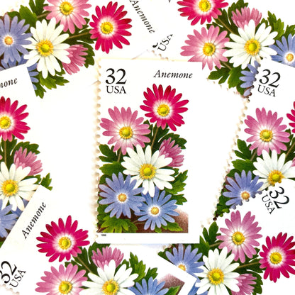 Image of Anemone postage stamps from the Winter Garden Flowers series, featuring a prink, purple, and white flowers with green foliage and garden soil on vintage unused 32-cent USPS postage, Scott Number 3029.