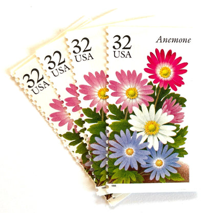 Image of Anemone postage stamps from the Winter Garden Flowers series, featuring a prink, purple, and white flowers with green foliage and garden soil on vintage unused 32-cent USPS postage, Scott Number 3029.