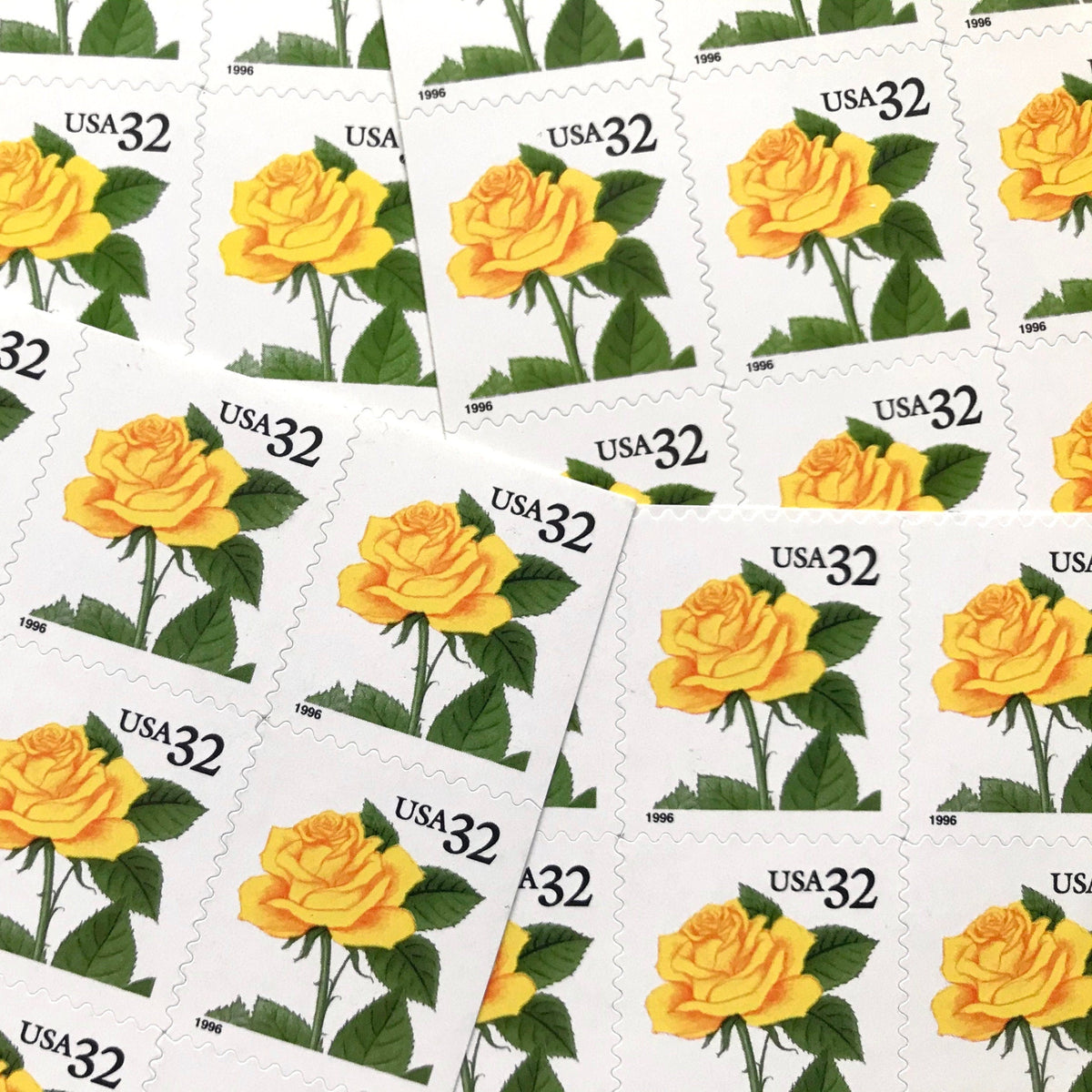 Vintage Yellow Rose postage stamps from the 1996 Flora & Fauna series featuring a bright yellow rose with green foliage on unused 32-cent USPS postage, Scott 3049.