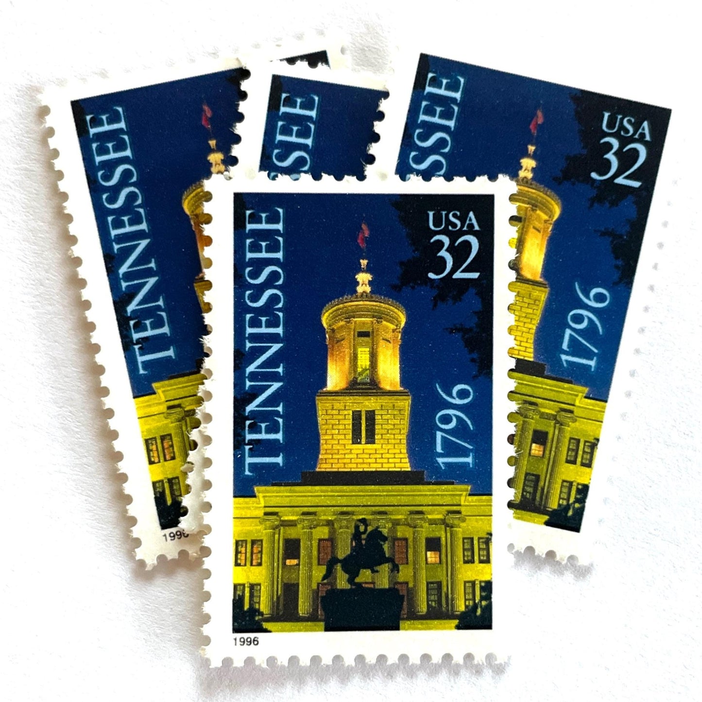 Image of Tennessee Statehood postage stamps from 1996, featuring the Tennessee State Capitol at night with an Andrew Jackson statue silhouette on vintage unused 32-cent USPS postage, Scott 3070.