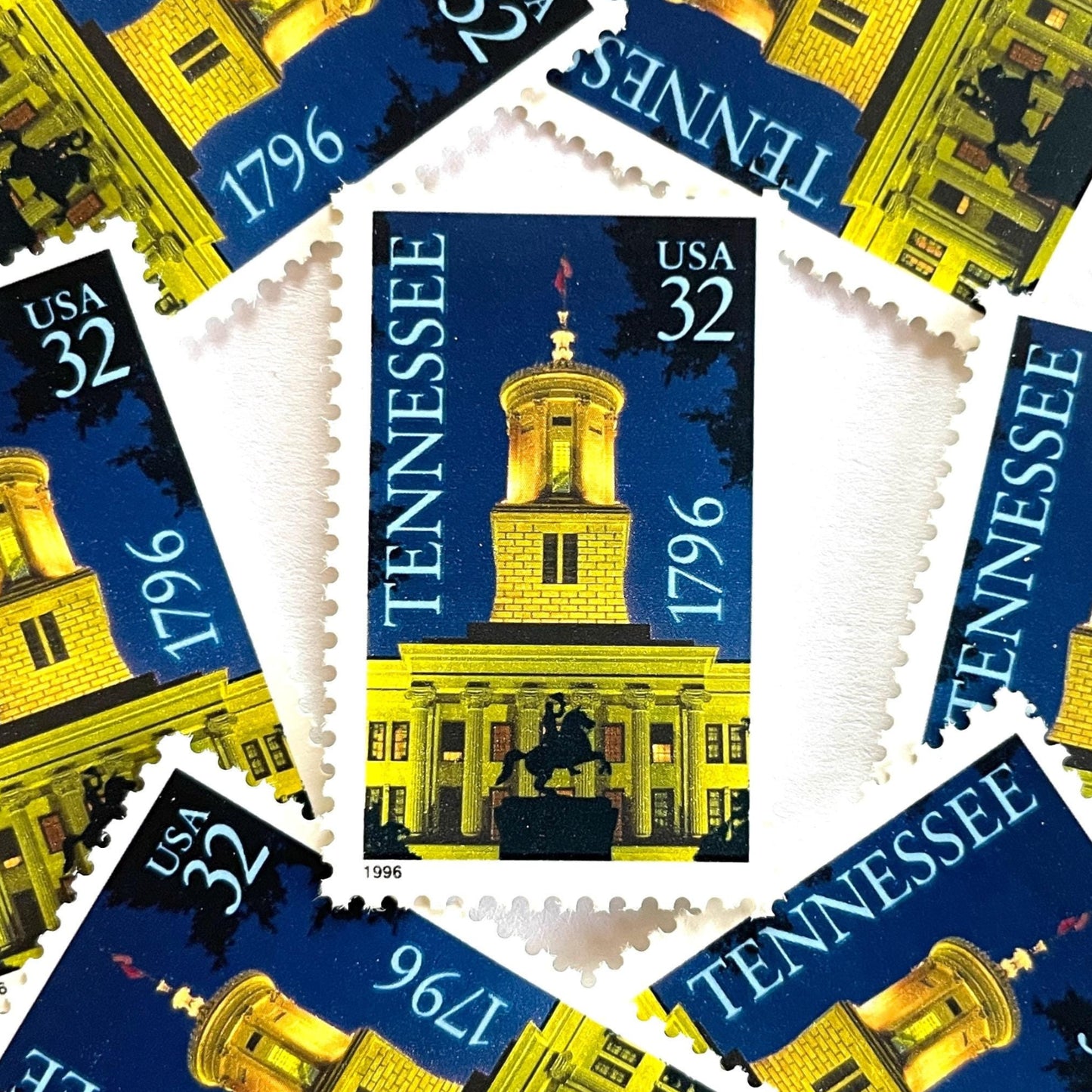 Image of Tennessee Statehood postage stamps from 1996, featuring the Tennessee State Capitol at night with an Andrew Jackson statue silhouette on vintage unused 32-cent USPS postage, Scott 3070.