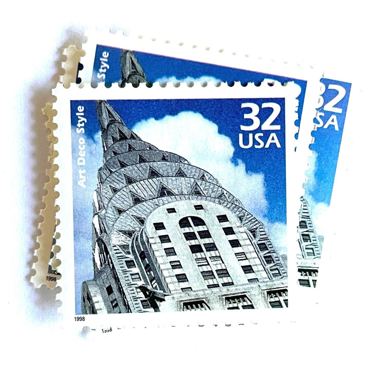 Image of 1998 Celebrate the Century - 1920s “Art Deco” 32-cent mail stamps. Scott #3184j. Stamp Themes: Art Deco Style, Chrysler Building, NYC, New York City. Blue and white postage stamp.