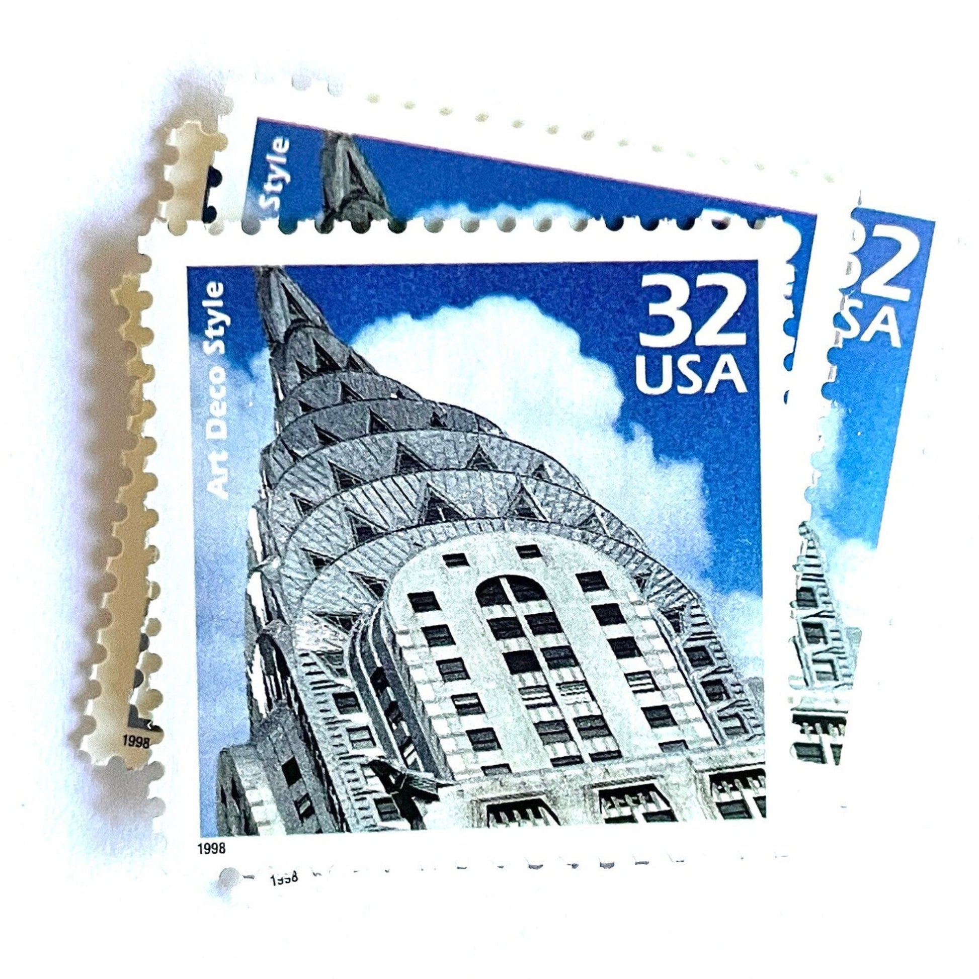 Image of 1998 Celebrate the Century - 1920s “Art Deco” 32-cent mail stamps. Scott #3184j. Stamp Themes: Art Deco Style, Chrysler Building, NYC, New York City. Blue and white postage stamp.