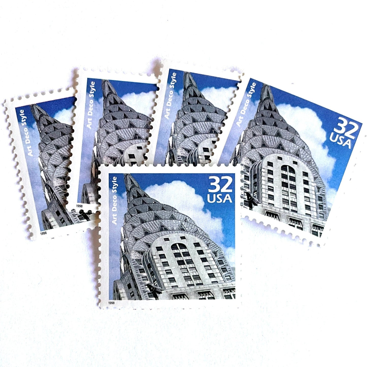 Image of 1998 Celebrate the Century - 1920s “Art Deco” 32-cent mail stamps. Scott #3184j. Stamp Themes: Art Deco Style, Chrysler Building, NYC, New York City. Blue and white postage stamp.