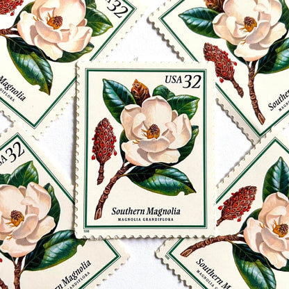 Southern Magnolia postage stamps from 1998 featuring large white magnolia blossoms and green foliage on vintage unused 32-cent USPS postage, Scott 3193.