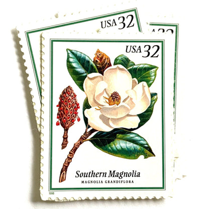 Southern Magnolia postage stamps from 1998 featuring large white magnolia blossoms and green foliage on vintage unused 32-cent USPS postage, Scott 3193.