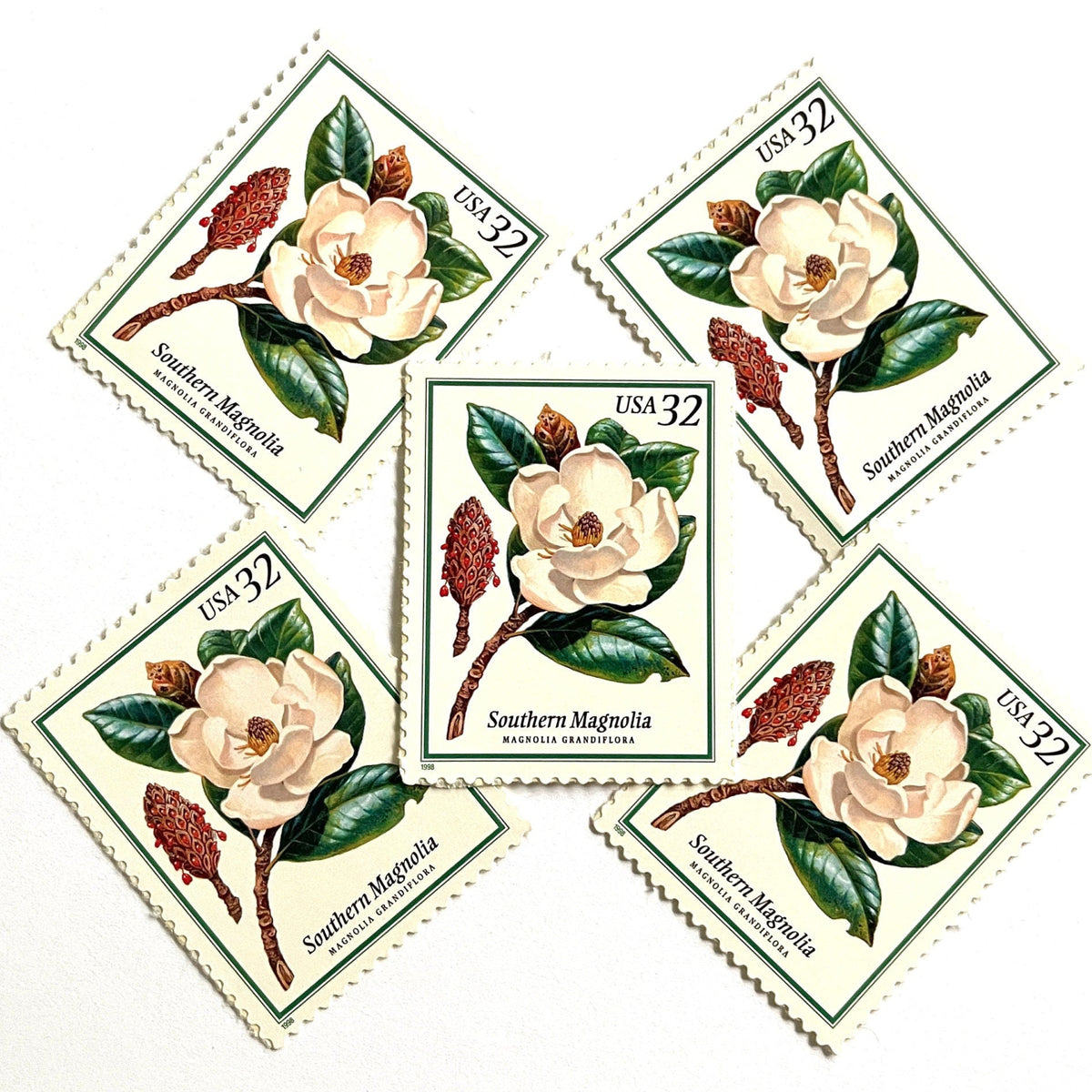Southern Magnolia postage stamps from 1998 featuring large white magnolia blossoms and green foliage on vintage unused 32-cent USPS postage, Scott 3193.
