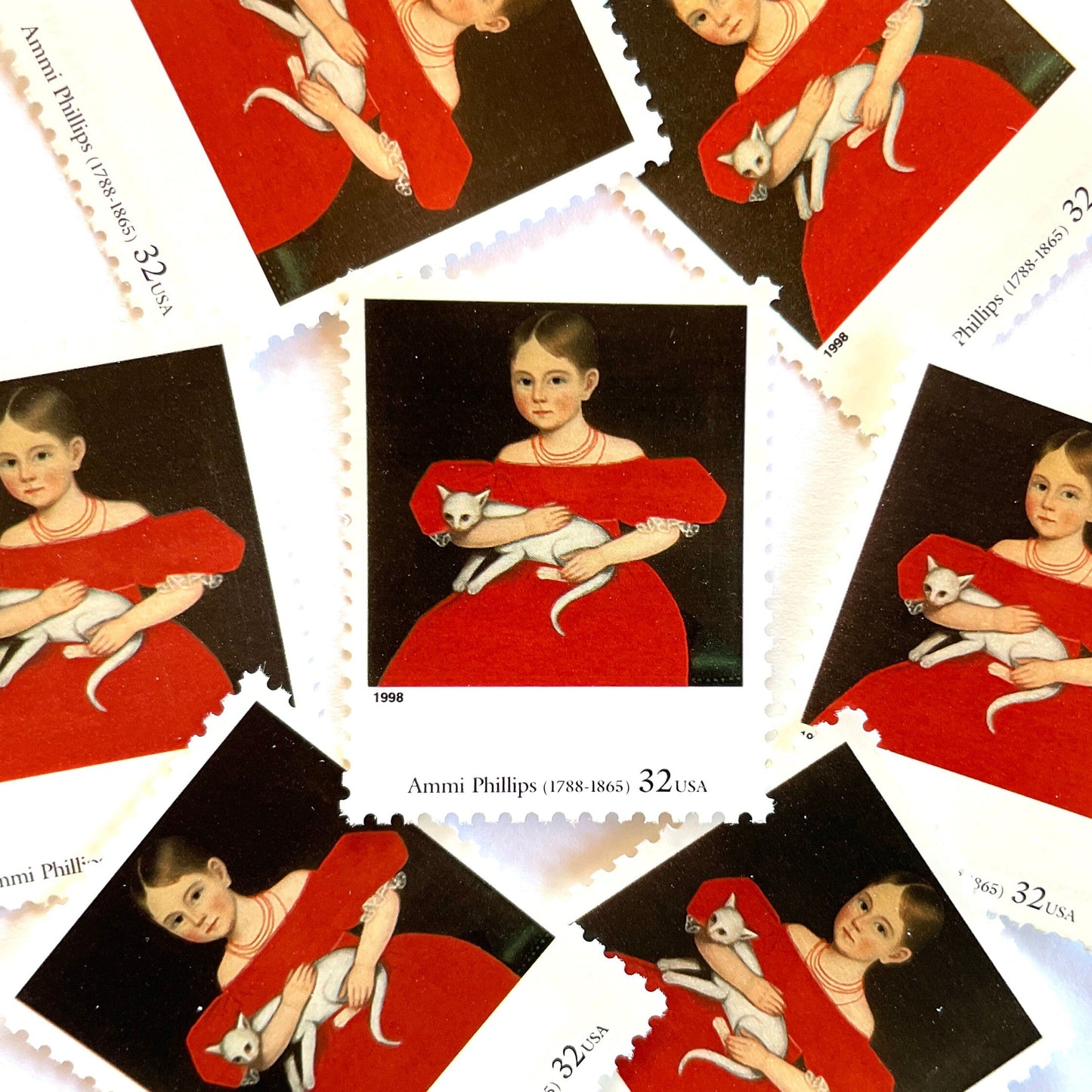 Ammi Phillips's "Girl in Red Dress with Cat and Dog" Postage Stamps from the 1998 Four Centuries of American Art Series. This postage stamp depicts a portrait painting of a young girl seated, wearing a red dress, sitting with a white cat in her arms. This vintage unused USPS Postage stamp is often used to mail wedding invitations, save the date invitations, and has a face value of 32 cents. Scott number 3236C.