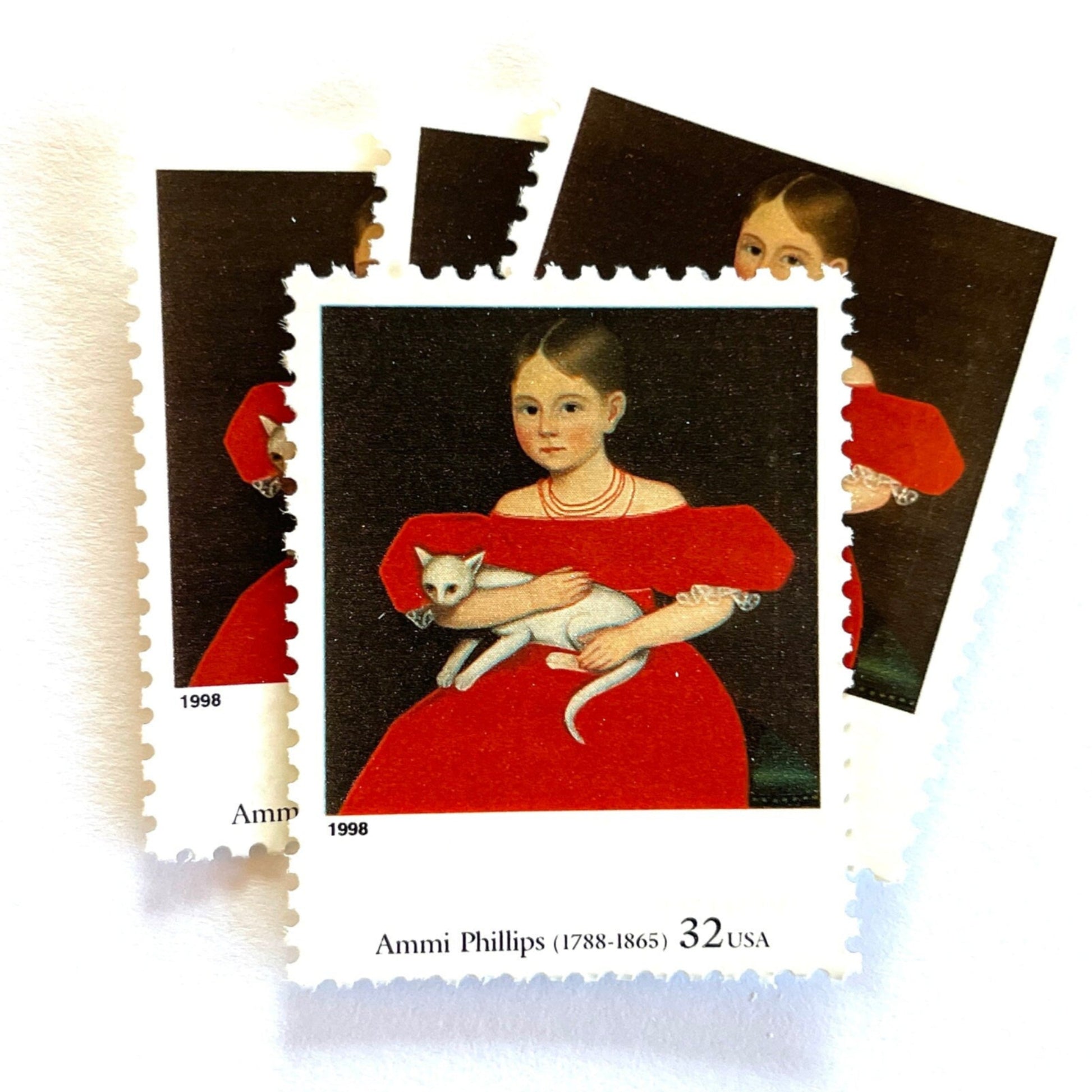 Ammi Phillips's "Girl in Red Dress with Cat and Dog" Postage Stamps from the 1998 Four Centuries of American Art Series. This postage stamp depicts a portrait painting of a young girl seated, wearing a red dress, sitting with a white cat in her arms. This vintage unused USPS Postage stamp is often used to mail wedding invitations, save the date invitations, and has a face value of 32 cents. Scott number 3236C.