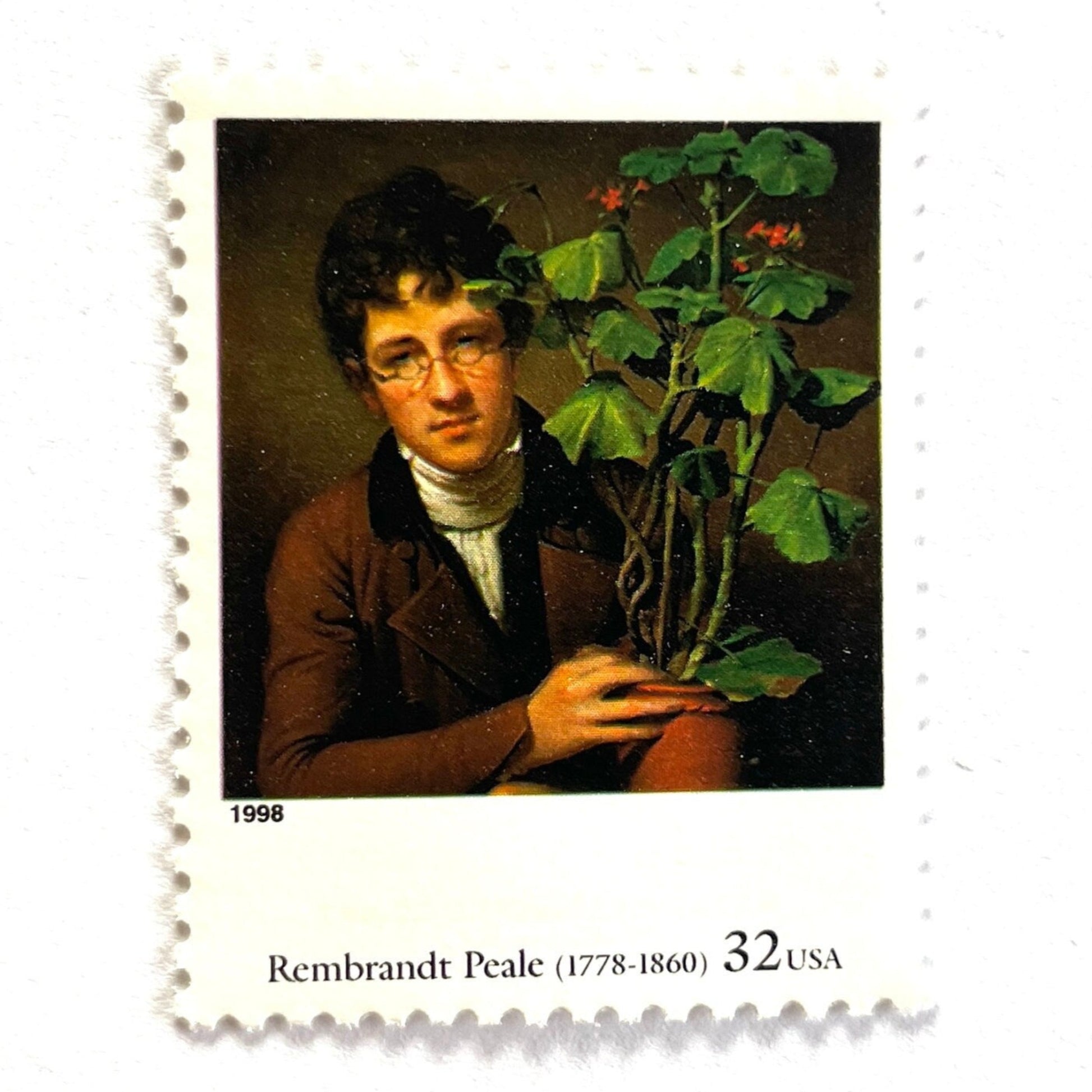 Close up image of Rembrandt Peale’s "Rubens Peale with a Geranium" Postage Stamp from the 1998 Four Centuries of American Art Series. This stamp depicts a painting the artist’s brother, a botanist, holding a potted plant. An iconic horticultural or gardening theme, this predominately brown postage stamp is often used to mail wedding invitations. These are vintage unused USPS postage stamps with a face value of 32 cents each. Scott number 3236D.