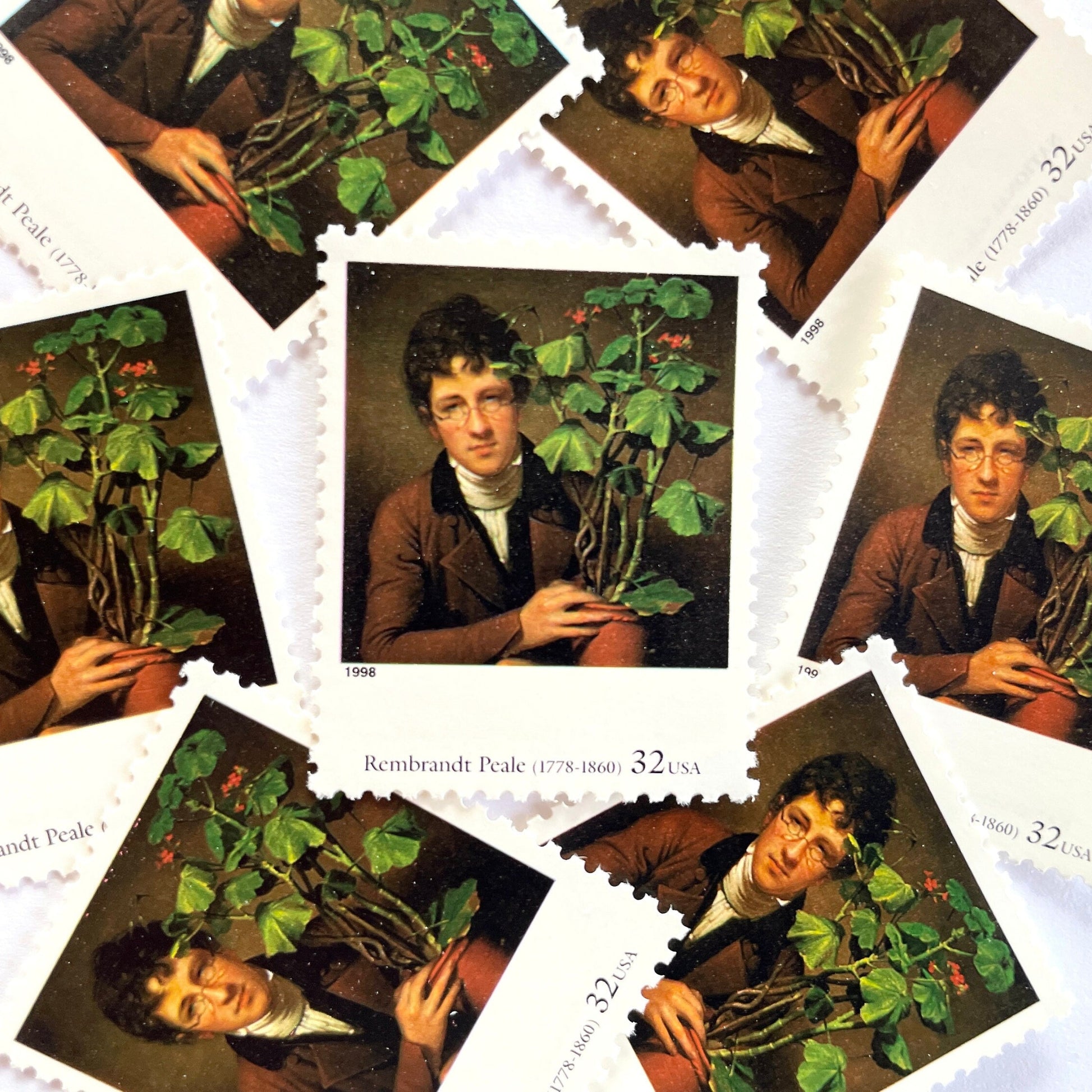 Rembrandt Peale’s "Rubens Peale with a Geranium" Postage Stamp from the 1998 Four Centuries of American Art Series. This stamp depicts a painting the artist’s brother, a botanist, holding a potted plant. An iconic horticultural or gardening theme, this predominately brown postage stamp is often used to mail wedding invitations. These are vintage unused USPS postage stamps with a face value of 32 cents each. Scott number 3236D.