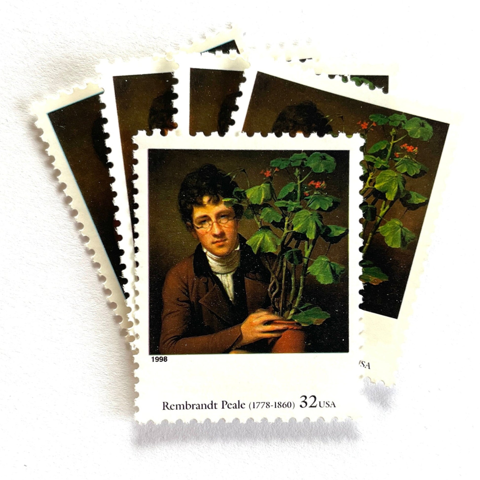 Rembrandt Peale’s "Rubens Peale with a Geranium" Postage Stamp from the 1998 Four Centuries of American Art Series. This stamp depicts a painting the artist’s brother, a botanist, holding a potted plant. An iconic horticultural or gardening theme, this predominately brown postage stamp is often used to mail wedding invitations. These are vintage unused USPS postage stamps with a face value of 32 cents each. Scott number 3236D.