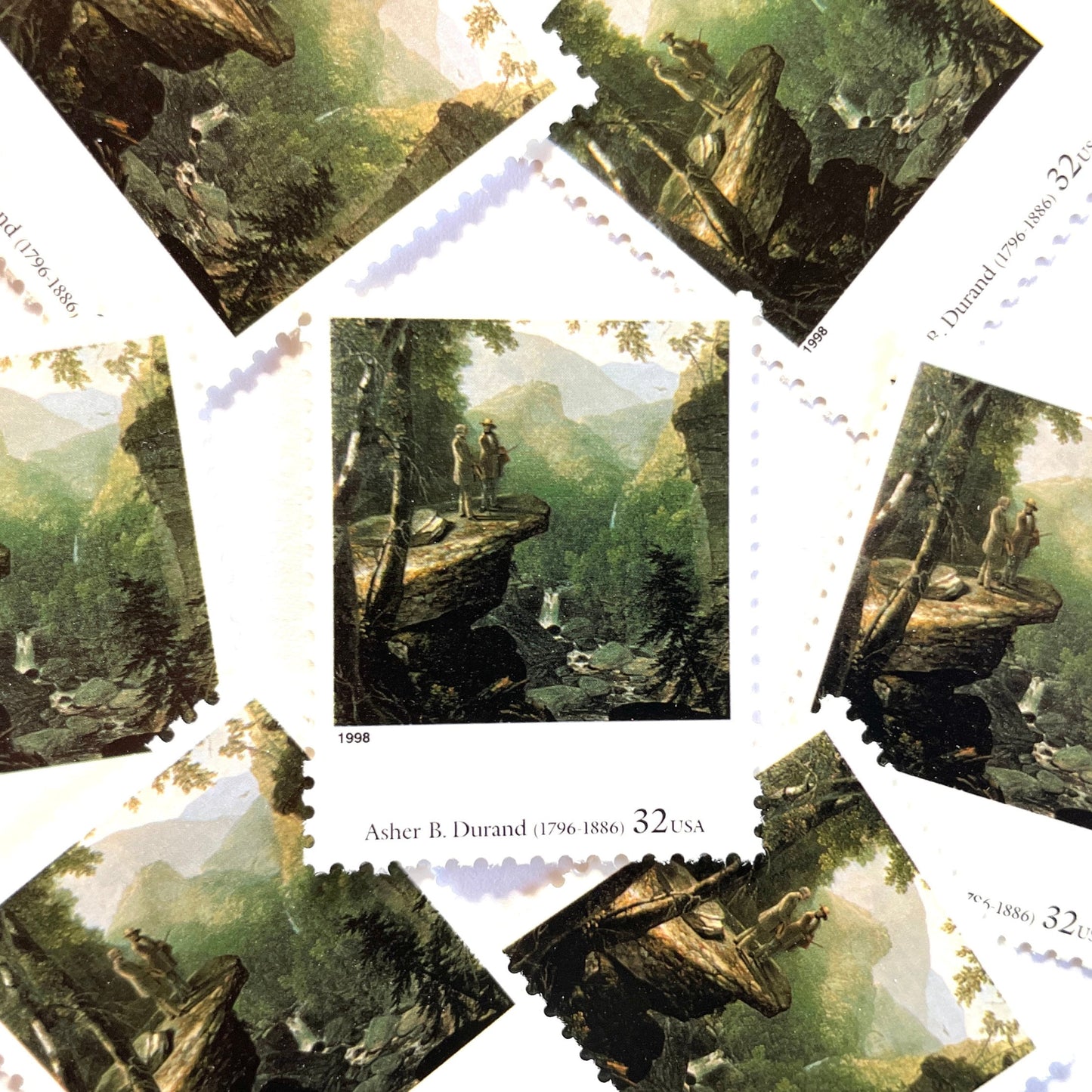 Asher B. Durand’s “Kindred Spirits” Postage Stamp from the 1998 Four Centuries of American Art Series. This stamp depicts two men talking while overlooking a vast western landscape with waterfalls in the background. An iconic nature theme, this predominately green postage stamp iconically depicts the American West. These are vintage unused USPS postage  stamps with a face value of 32 cents. Scott number 3236G.