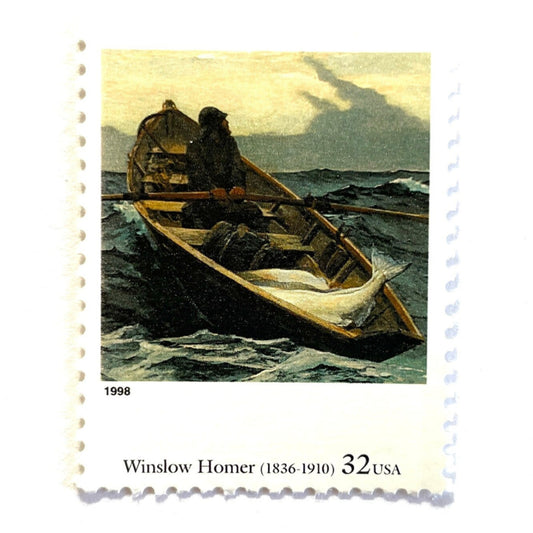 Close up image of Winslow Homer’s "The Fog Warning" Postage Stamp from the 1998 Four Centuries of American Art Series. This stamp depicts a painting of a lone rowboat in choppy water, with fish on board, as the oarsman rows towards shore before the impending storm. An iconic nautical theme, this postage stamp is often used to mail wedding invitations. These are vintage unused USPS postage stamps with a face value of 32 cents each. Scott number 3236J.