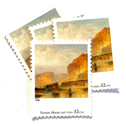 Thomas Moran’s “Cliffs of Green River" Postage Stamp from the 1998 Four Centuries of American Art Series. This stamp depicts a western landscape painting of the Green River at sunset or sunrise. An iconic nature theme, this predominately beige or neutral postage stamp depicts a lone horseback rider and is often used to mail wedding invitations. These are vintage unused USPS postage stamps with a face value of 32 cents each. Scott number 3236L.