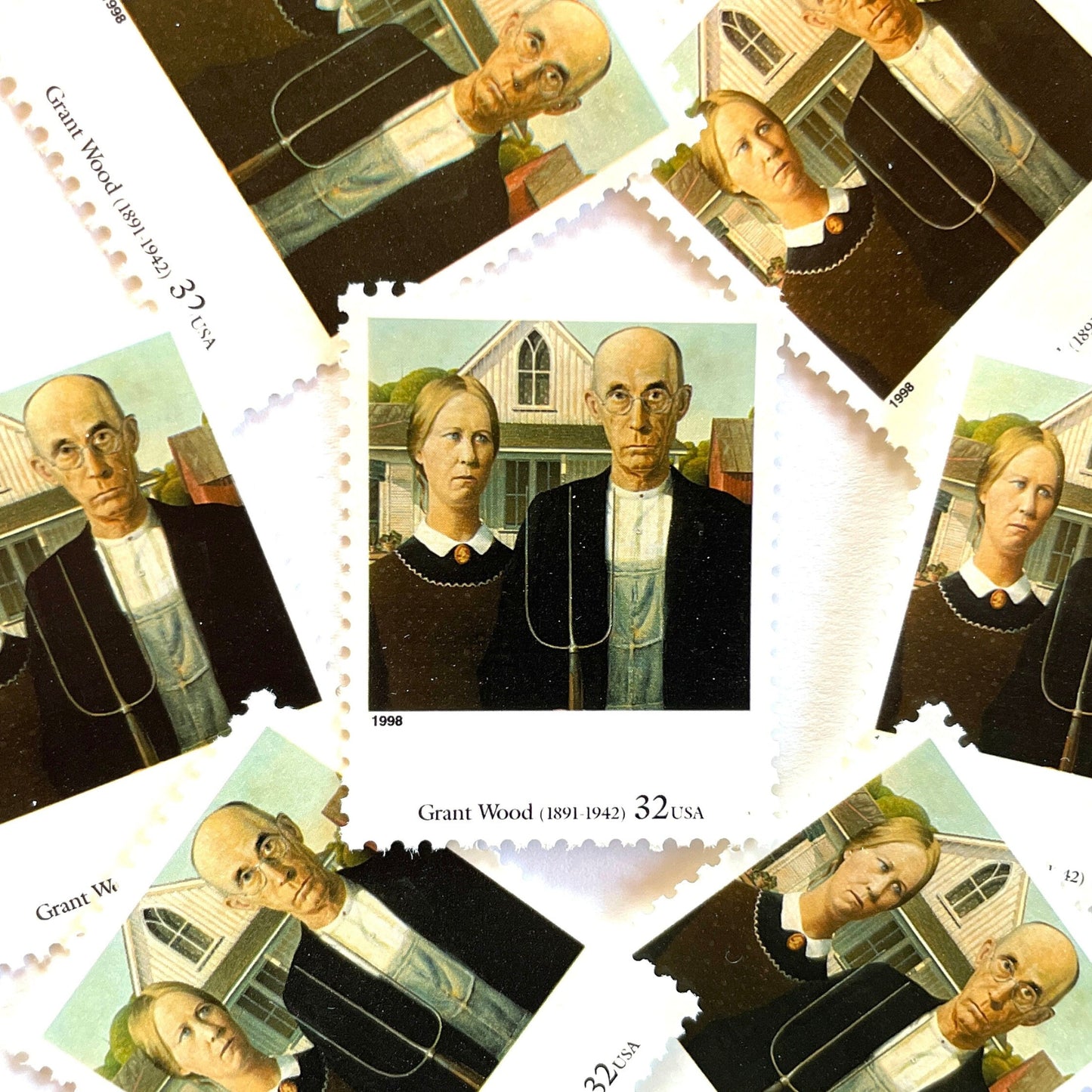 Grant Wood’s “American Gothic” Postage Stamp from the 1998 Four Centuries of American Art Series. This stamp depicts the iconic painting of man and woman, farmers or gardeners, standing in front of a farmhouse with a gothic style window. The man is holding a pitchfork. An iconic homesteading theme, this postage stamp depicts a couple and is often used for mailing wedding invitations and save the dates. These are vintage unused USPS postage stamps with a face value of 32 cents each. Scott number 3236Q.