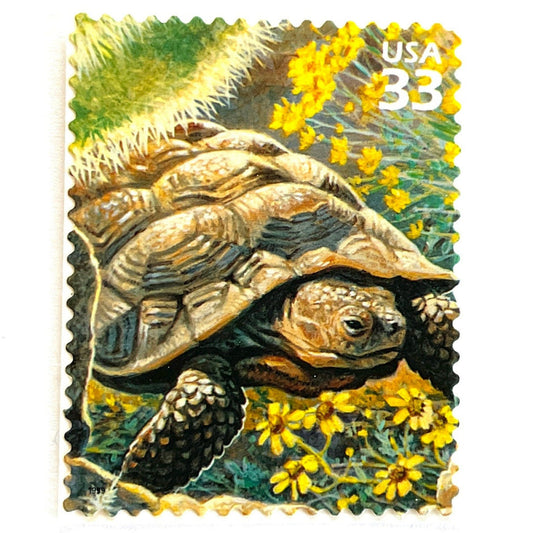 Image of Desert Tortoise postage stamps from the 1999 Nature of America Sonoran Desert issue, featuring a brown desert tortoise set in yellow flowers and cactus in a Southwestern landscape on vintage unused 33-cent USPS postage, Scott 3293b.