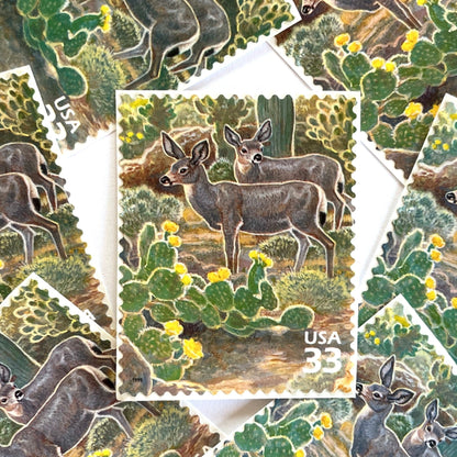 Image of Desert Mule Deer postage stamps from the 1999 Nature of America Sonoran Desert series, featuring brown mule deer standing amongst green cactus with yellow flowers in a Southwestern desert landscape on vintage unused 33-cent USPS postage, Scott 3293f.