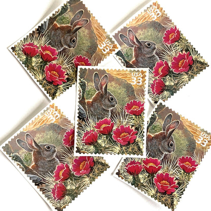 Image of Desert Cottontail rabbit postage stamps from the 1999 Nature of America Sonoran Desert issue, featuring a brown desert bunny perched in pink flowering cactus in a Southwestern landscape scene on vintage unused 33-cent USPS postage, Scott 3293g.