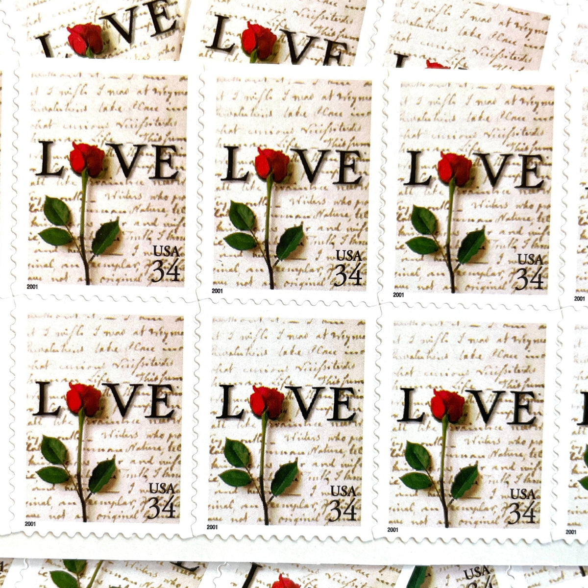 Rose & Love Letter postage stamps from 2001 featuring a red rose over John Adams’s handwritten love letter to Abigail Smith on vintage unused 34-cent USPS postage, Scott 3497.