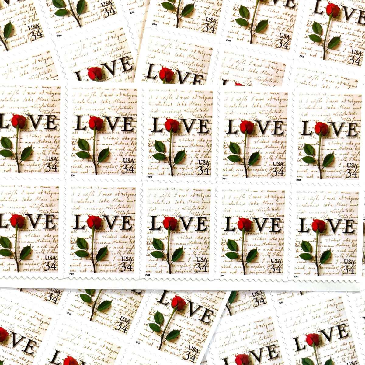 Rose & Love Letter postage stamps from 2001 featuring a red rose over John Adams’s handwritten love letter to Abigail Smith on vintage unused 34-cent USPS postage, Scott 3497.