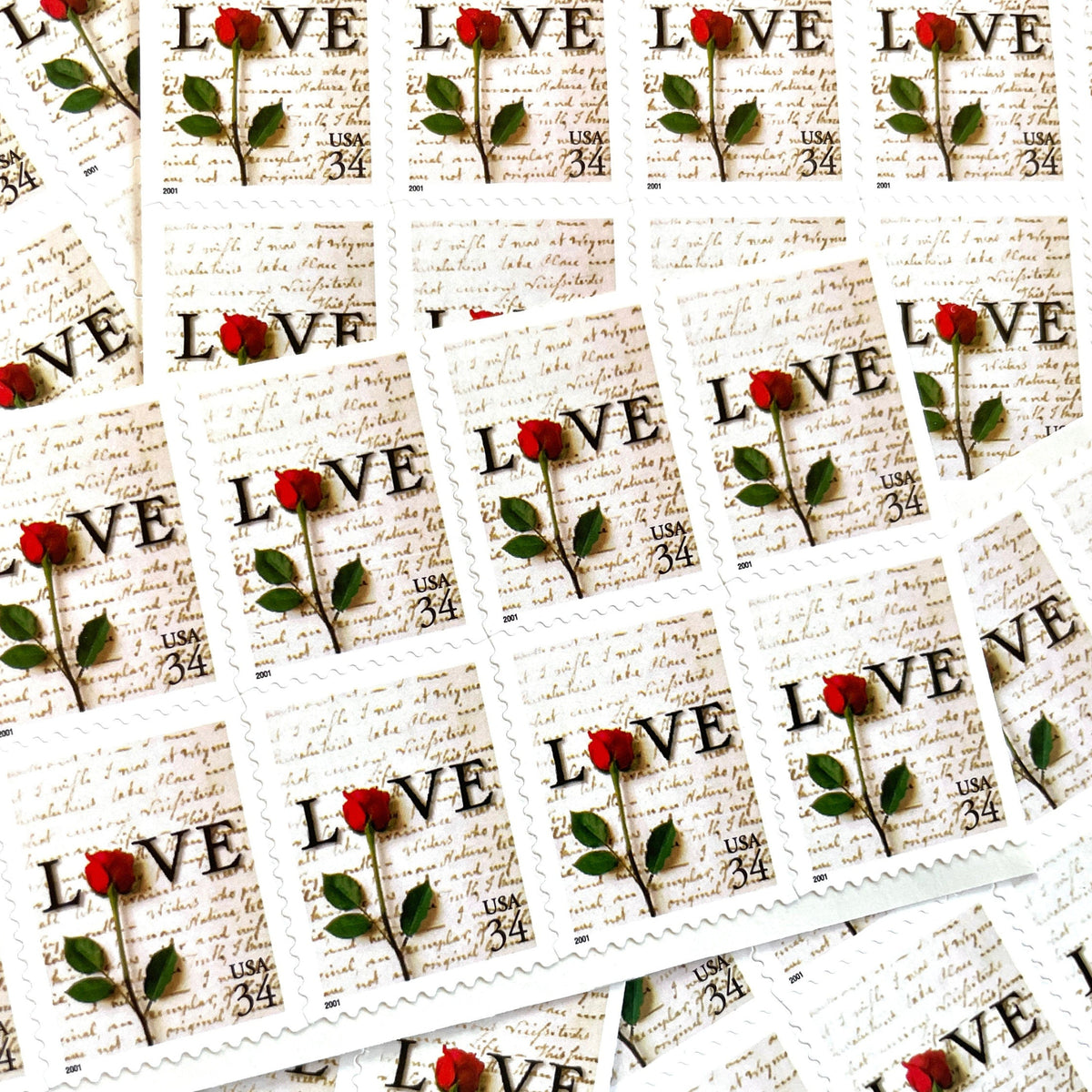 Rose & Love Letter postage stamps from 2001 featuring a red rose over John Adams’s handwritten love letter to Abigail Smith on vintage unused 34-cent USPS postage, Scott 3497.