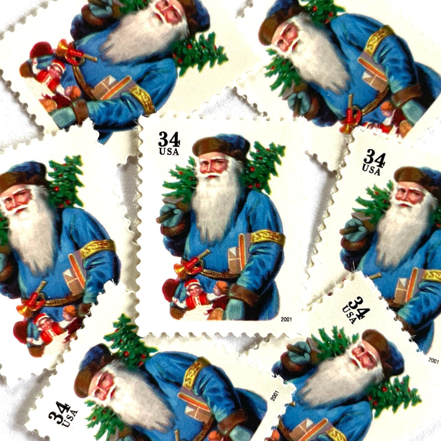 Image of 34-cent Contemporary Christmas 2001 Santa Claus Se-tenant "Santa with Horn" and blue coat USPS postage stamps featuring a relatively skinny white bearded Santa wearing a brown, hooded robe over a red suit. This jolly looking Santa is portly and jovial with a full white beard, a blue suit trimmed in gold, a blue cap, and a small horn attached to his belt. Scott #3538. Stamp themes: Christmas, holidays, winter, Santa Claus, toys, gifts, winter wedding, winter save-the-date. Blue postage stamp.