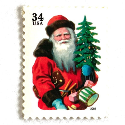Image of 34-cent Contemporary Christmas 2001 Santa Claus Se-tenant "Santa with Red Hat" and Christmas Tree USPS postage stamp featuring a portly and jovial Santa holding a Christmas tree, with a full white beard and a warm, inviting smile, gazing directly out from the stamp. He is wearing a red suit trimmed with brown fur, and a red cap. Scott #3539. Stamp themes: Christmas, holidays, winter, Santa Claus, toys, gifts, winter wedding, winter save-the-date. Red postage stamp.