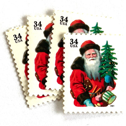 Image of 34-cent Contemporary Christmas 2001 Santa Claus Se-tenant "Santa with Red Hat" and Christmas Tree USPS postage stamps featuring a portly and jovial Santa holding a Christmas tree, with a full white beard and a warm, inviting smile, gazing directly out from the stamp. He is wearing a red suit trimmed with brown fur, and a red cap. Scott #3539. Stamp themes: Christmas, holidays, winter, Santa Claus, toys, gifts, winter wedding, winter save-the-date. Red postage stamp.