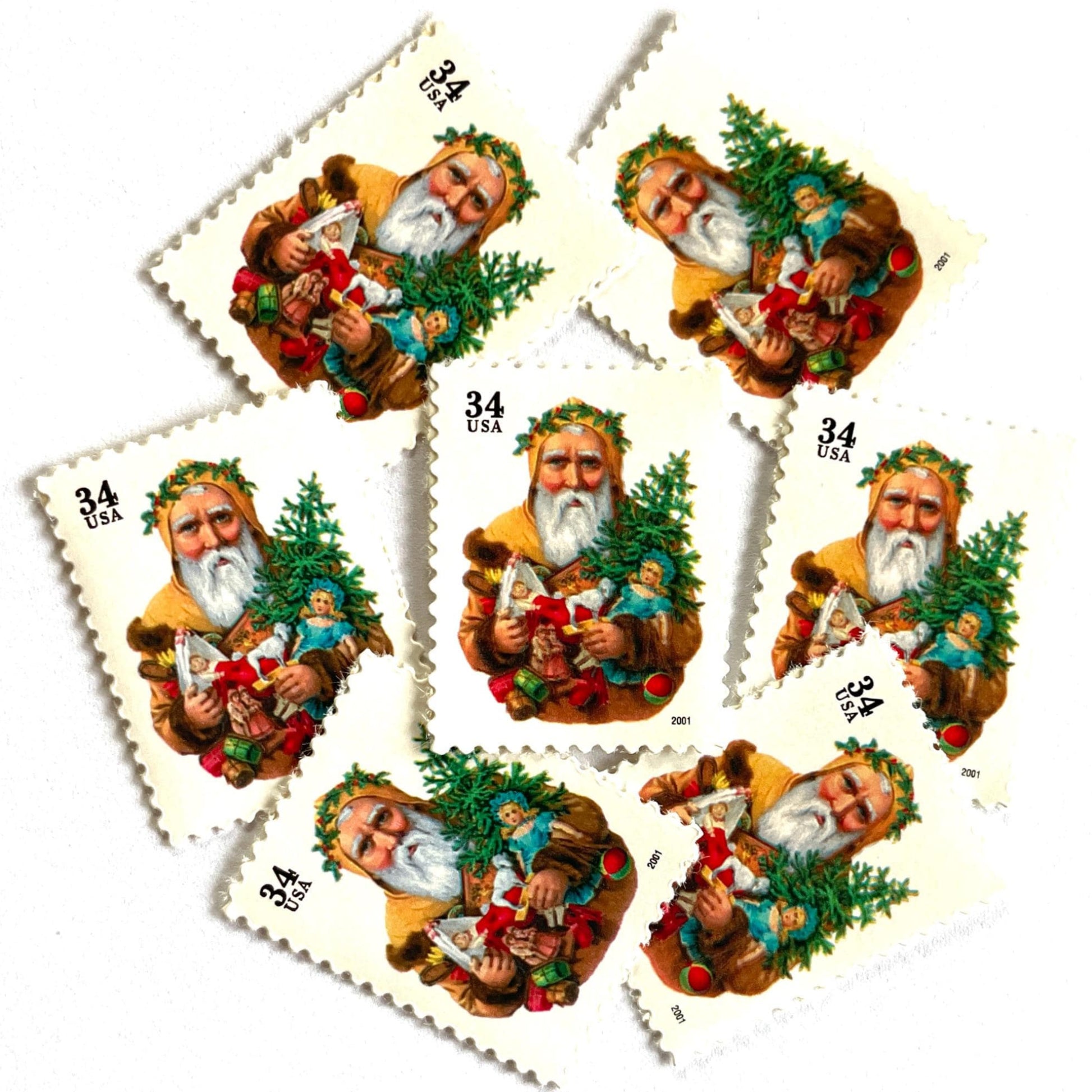 Image of 34-cent Contemporary Christmas 2001 Santa Claus Se-tenant "Santa with Dog” and Christmas Tree USPS postage stamp featuring an “old world" bearded Santa Claus shown in a long, brown, fur-trimmed robe with a hood. He wears a crown of green leaves or holly and holds an open book in one hand. He carries several traditional toys, including a toy dog, a doll, and a small Christmas tree. Scott #3540. Stamp themes: Christmas, holidays, winter, Santa Claus, toys, gifts, winter wedding, winter save-the-date.