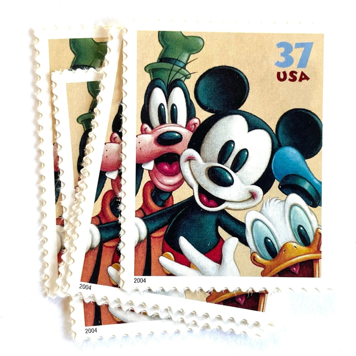Mickey Mouse, Goofy and Donald Duck postage stamps from 2004 featuring the classic Disney friends on vintage unused 37-cent USPS postage, Scott 3865.