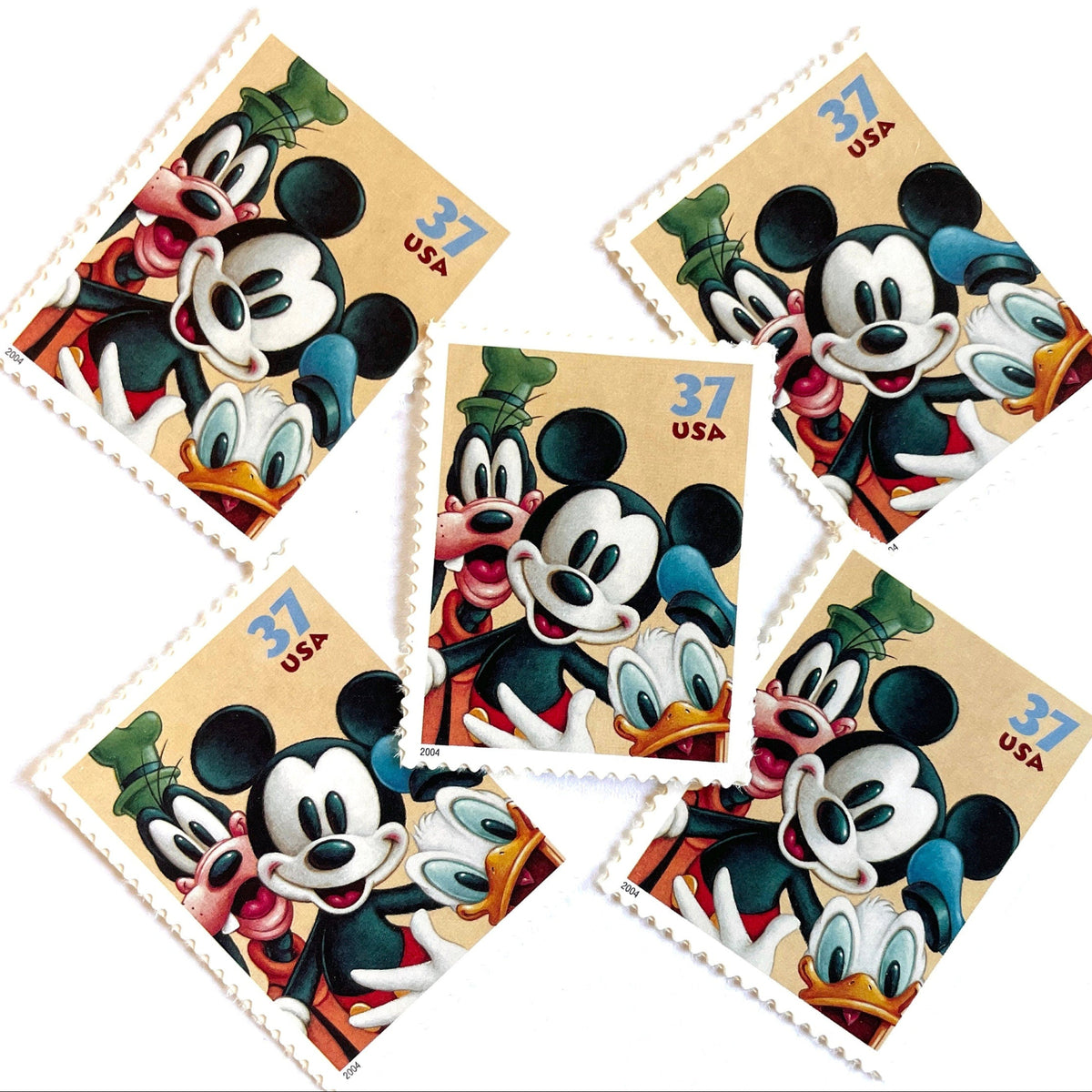 Mickey Mouse, Goofy and Donald Duck postage stamps from 2004 featuring the classic Disney friends on vintage unused 37-cent USPS postage, Scott 3865.