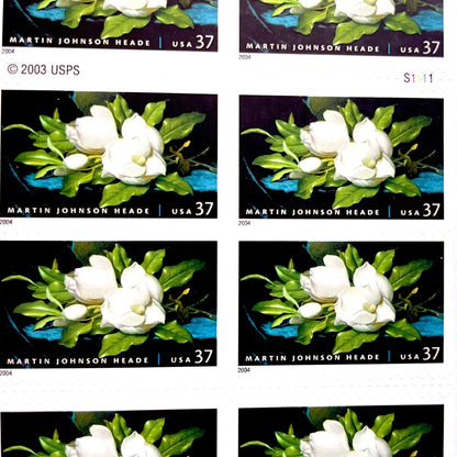 Image of 2004 American Treasures series “Martin Johnson Heade Painting” ("Giant Magnolias on a Blue Velvet Cloth”) unused 37-cent vintage USPS mail stamps. Scott #3872. Stamp Themes: Flowers, White Flowers, Floral, Botanical, Gardening, American Trees, Magnolia Tree, Magnolia Flowers. Dark Blue, Black, White, Green, Multicolored self-adhesive postage stamp. Perfect postage stamp to use for save the date announcements, wedding invitation postage, bridal shower invitations, birth announcements, thank you card